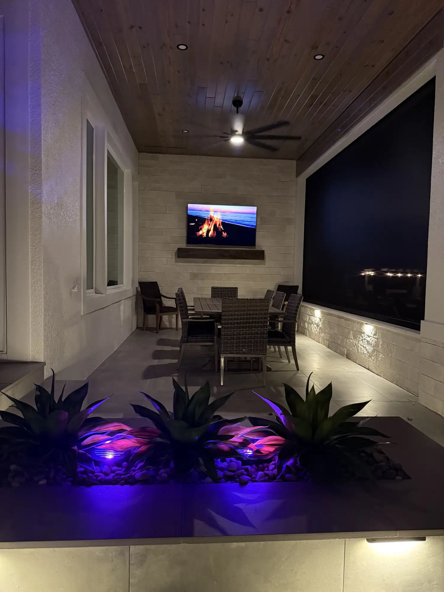 The lanai and water feature with accent lighting in Apopka, FL