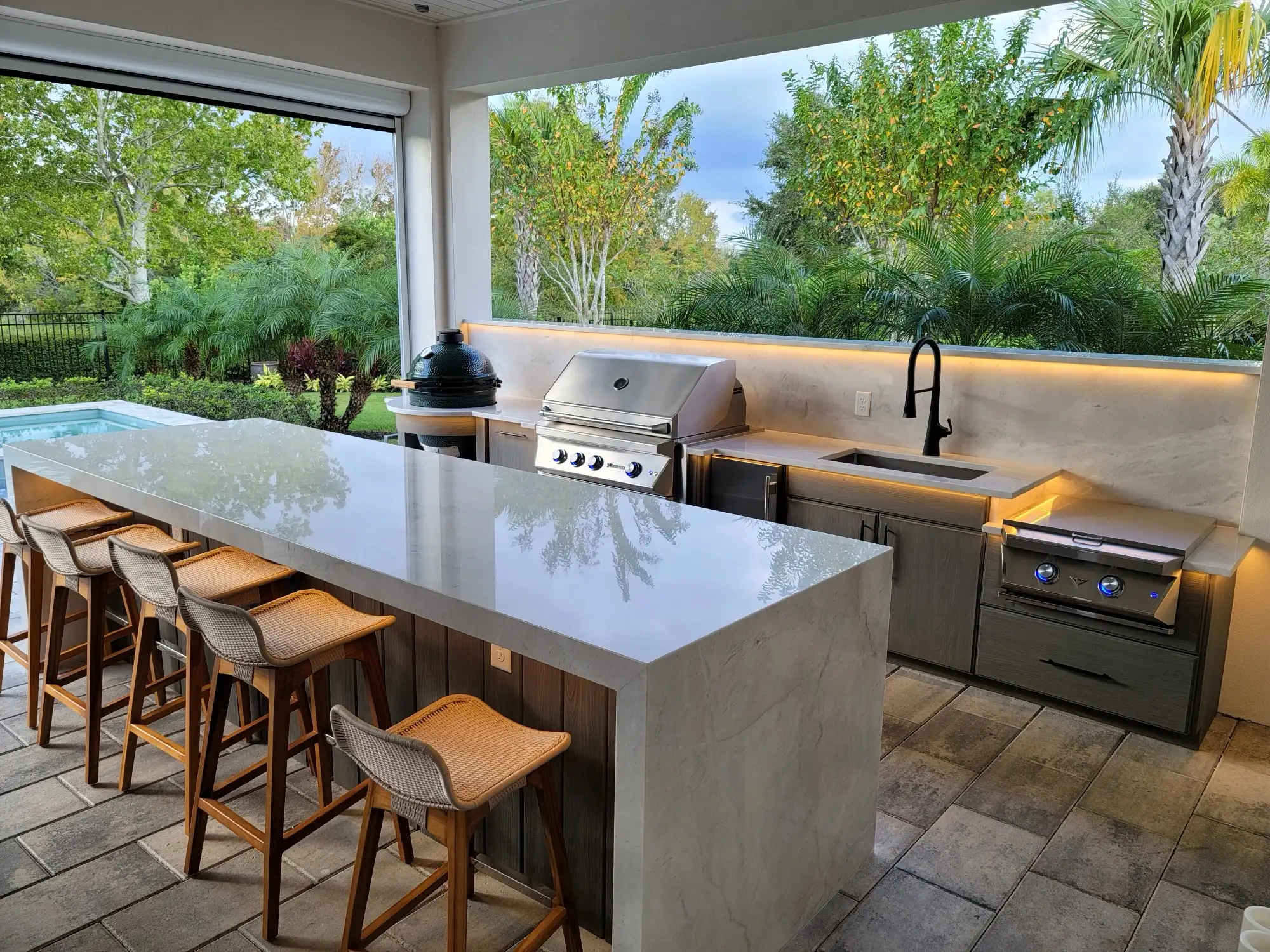 Built-in grill and stone backsplash detail at an Orlando outdoor kitchen