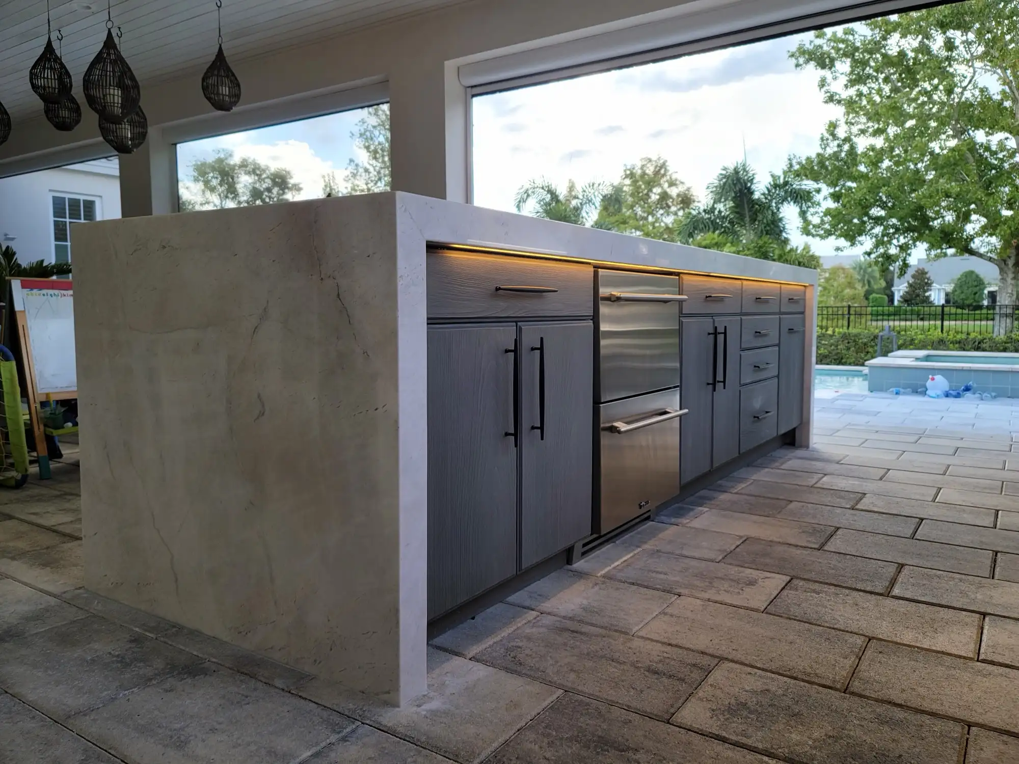 Marble waterfall island and cabinetry at an Orlando outdoor kitchen