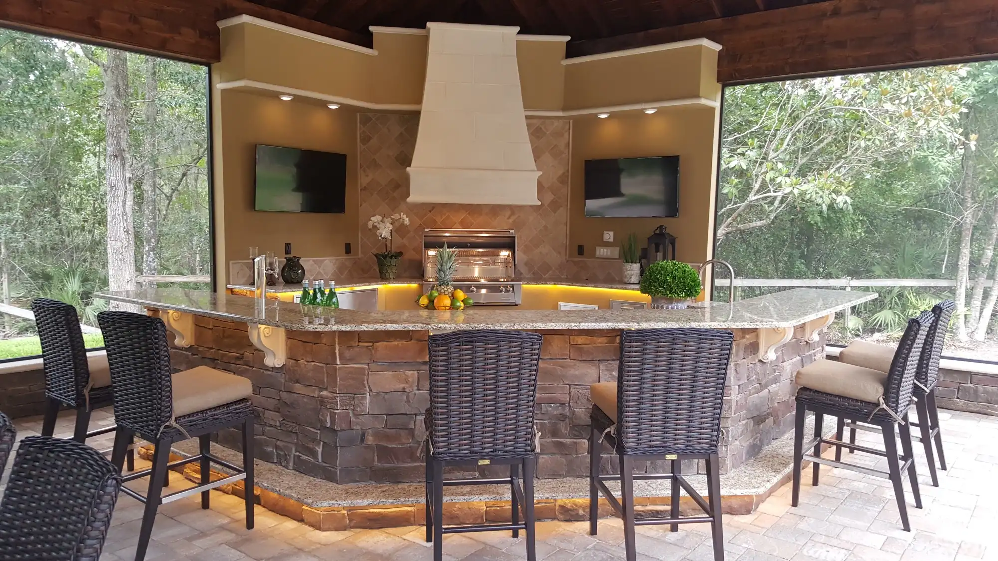 The detached outdoor structure across the pool from the home