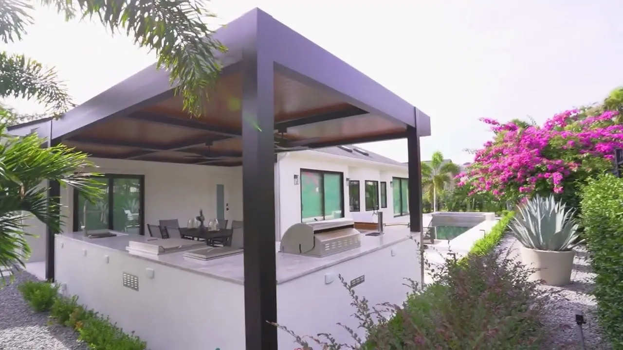 Black Azenco Outdoor R-SHADE patio cover over a poolside patio in Central Florida